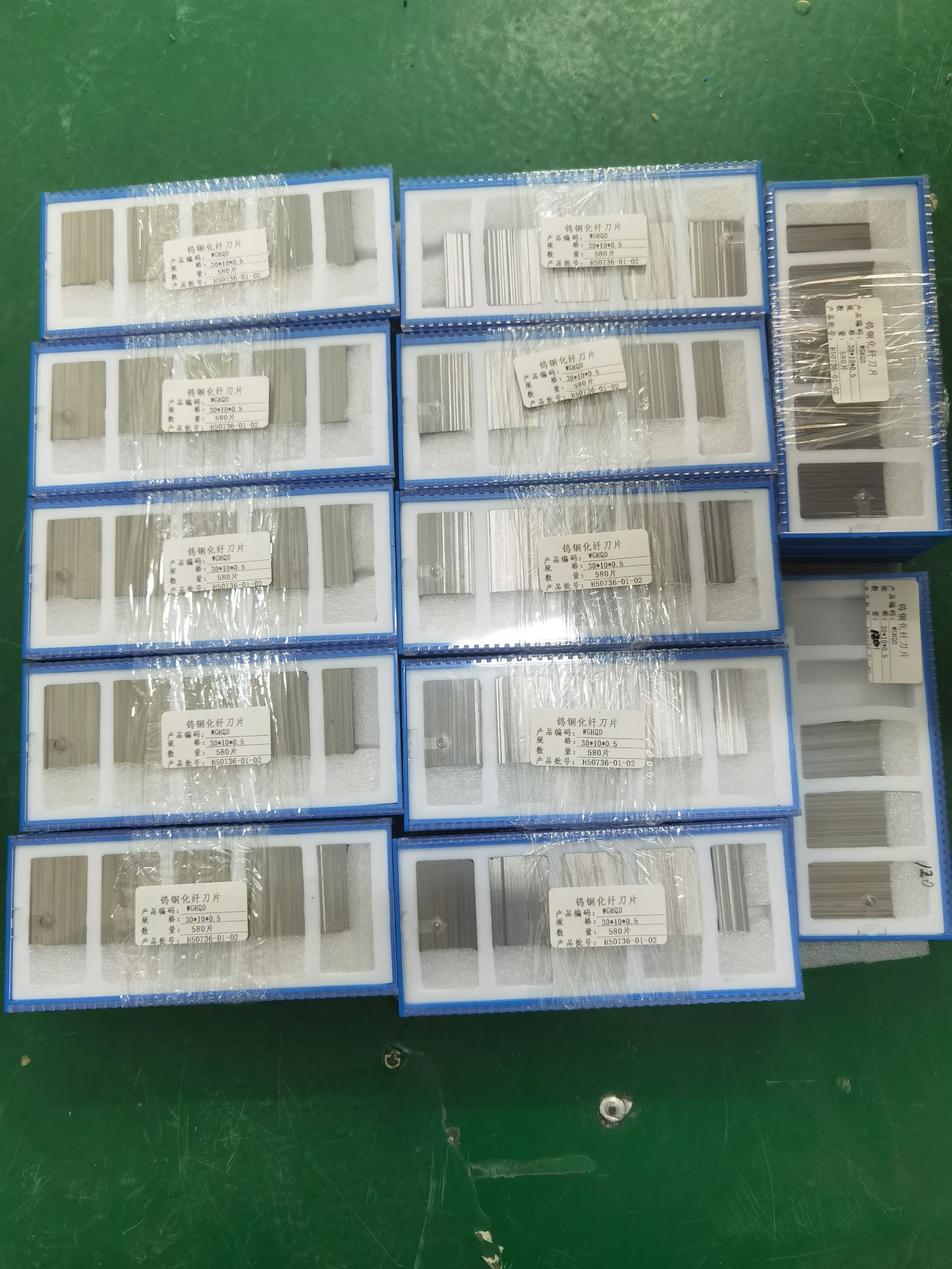 Chemical fiber cutting blades in foam-lined boxes labeled 30 by 10 by 0.5 mm