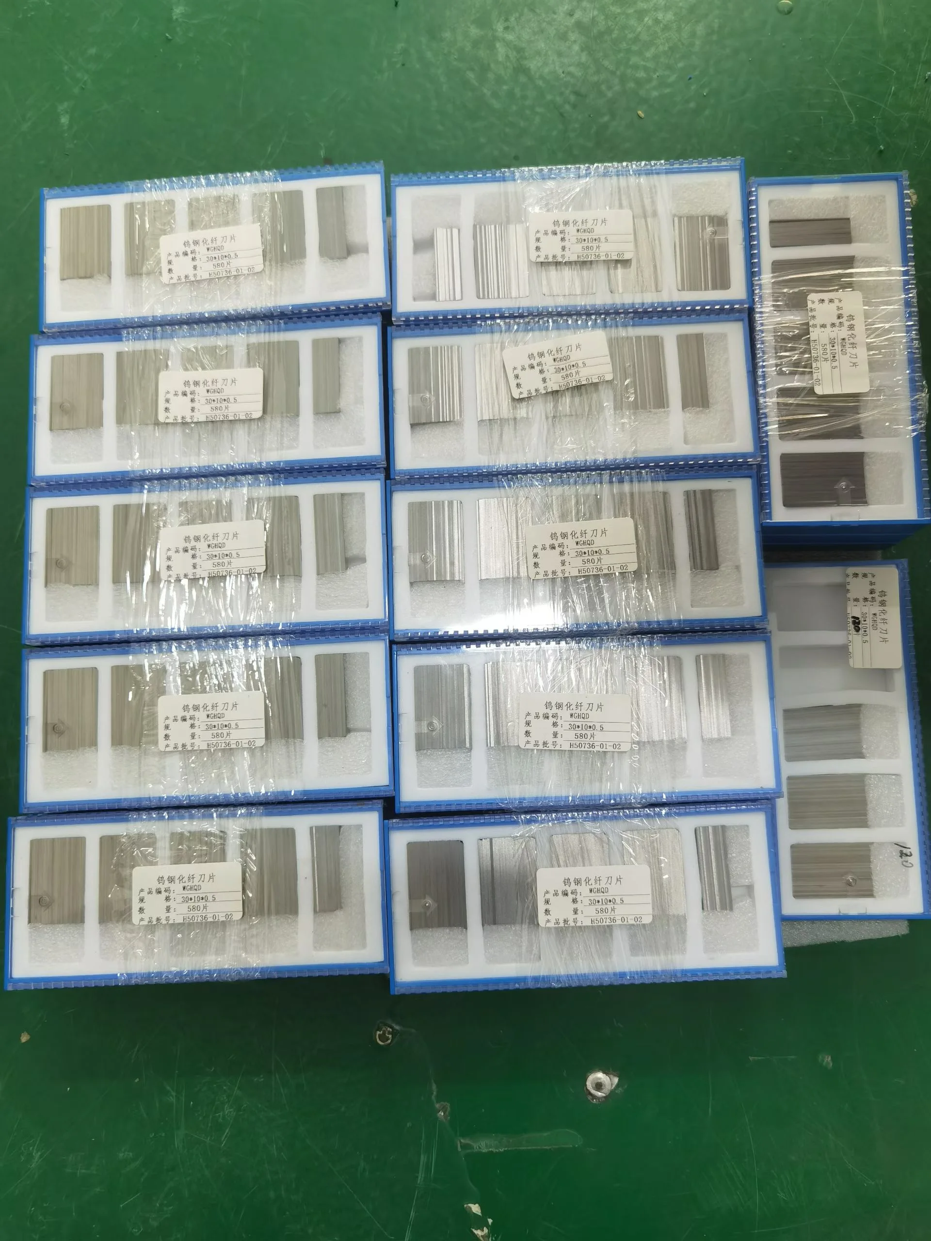 Chemical fiber cutting blades in foam-lined boxes labeled 30 by 10 by 0.5 mm