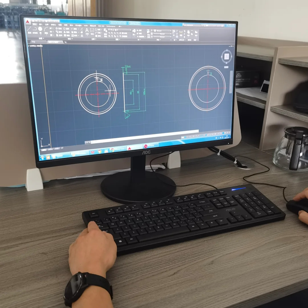 CAD drawing of a circular blade on a monitor during custom industrial knife review at MEIRENTE